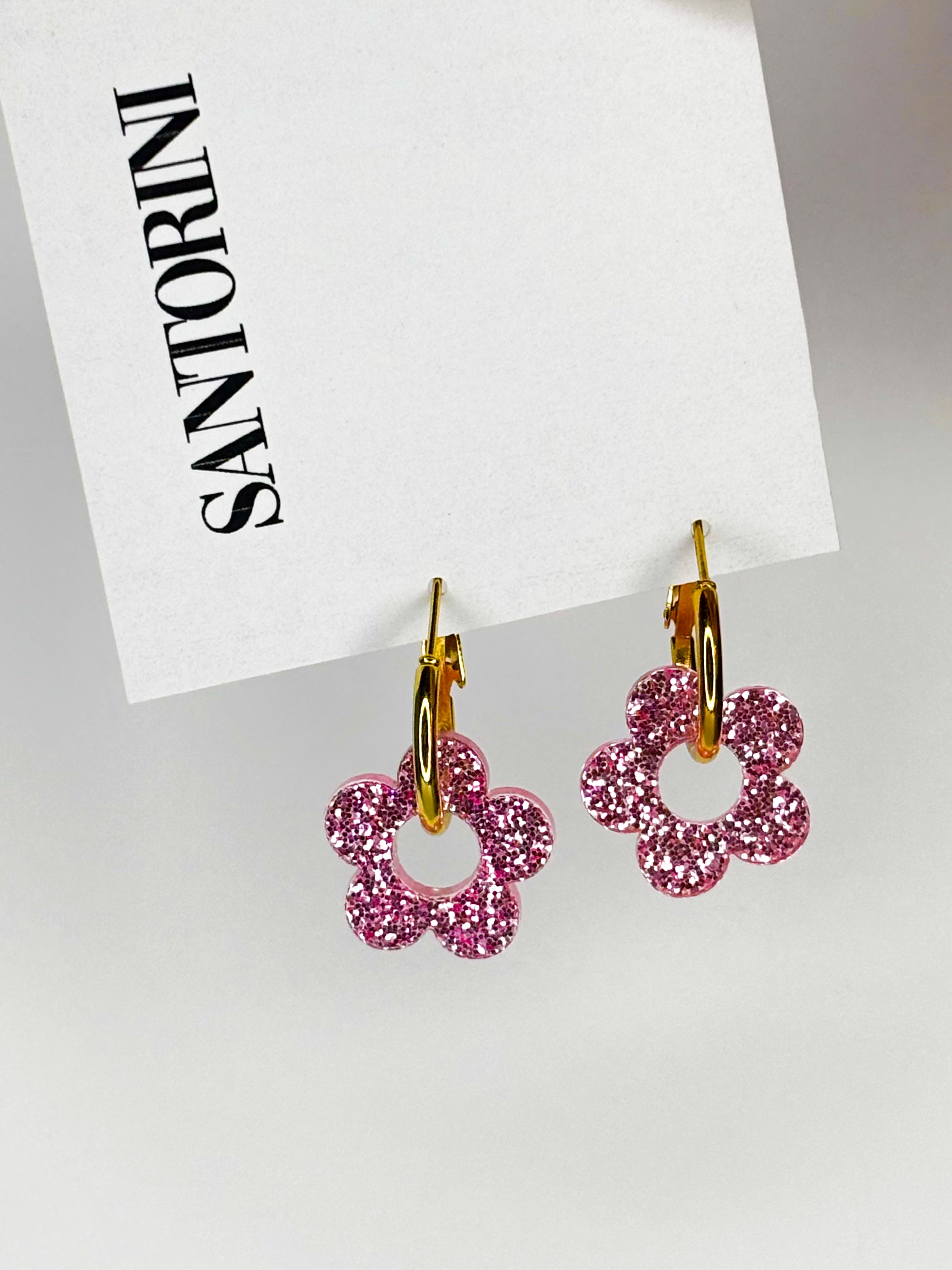 Aritos florcitas brillantina fucsia